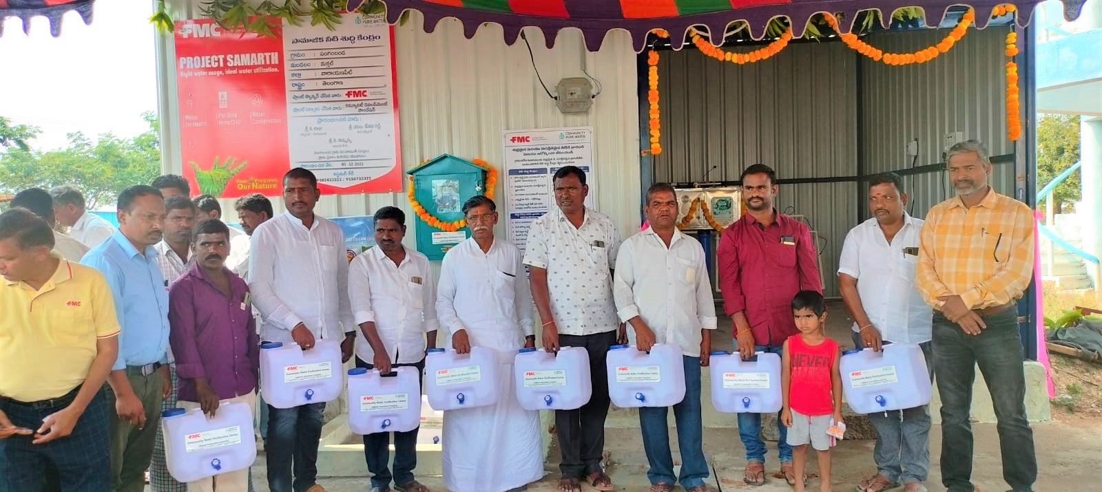 Residents of Narayanpet, India visits the village's newly installed water filtration plant, courtesy of FMC India. Facing the camera, they are carrying containers which they will use to collect free potable drinking water from the plant. The new filtration plant in Naraynanpath is one of two water filtration plants in India's Telangana state that were recently inaugurated by FMC India and local dignitaries. 