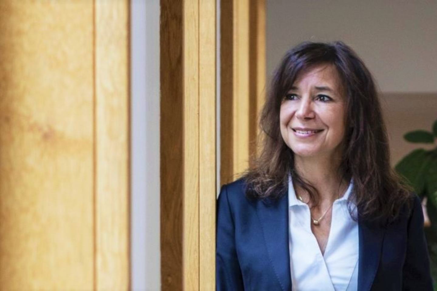 Dr. Bénédicte Flambard, elected vice president of Plant Health at FMC, stands before a window. She is wearing a dark suit and white shirt. 