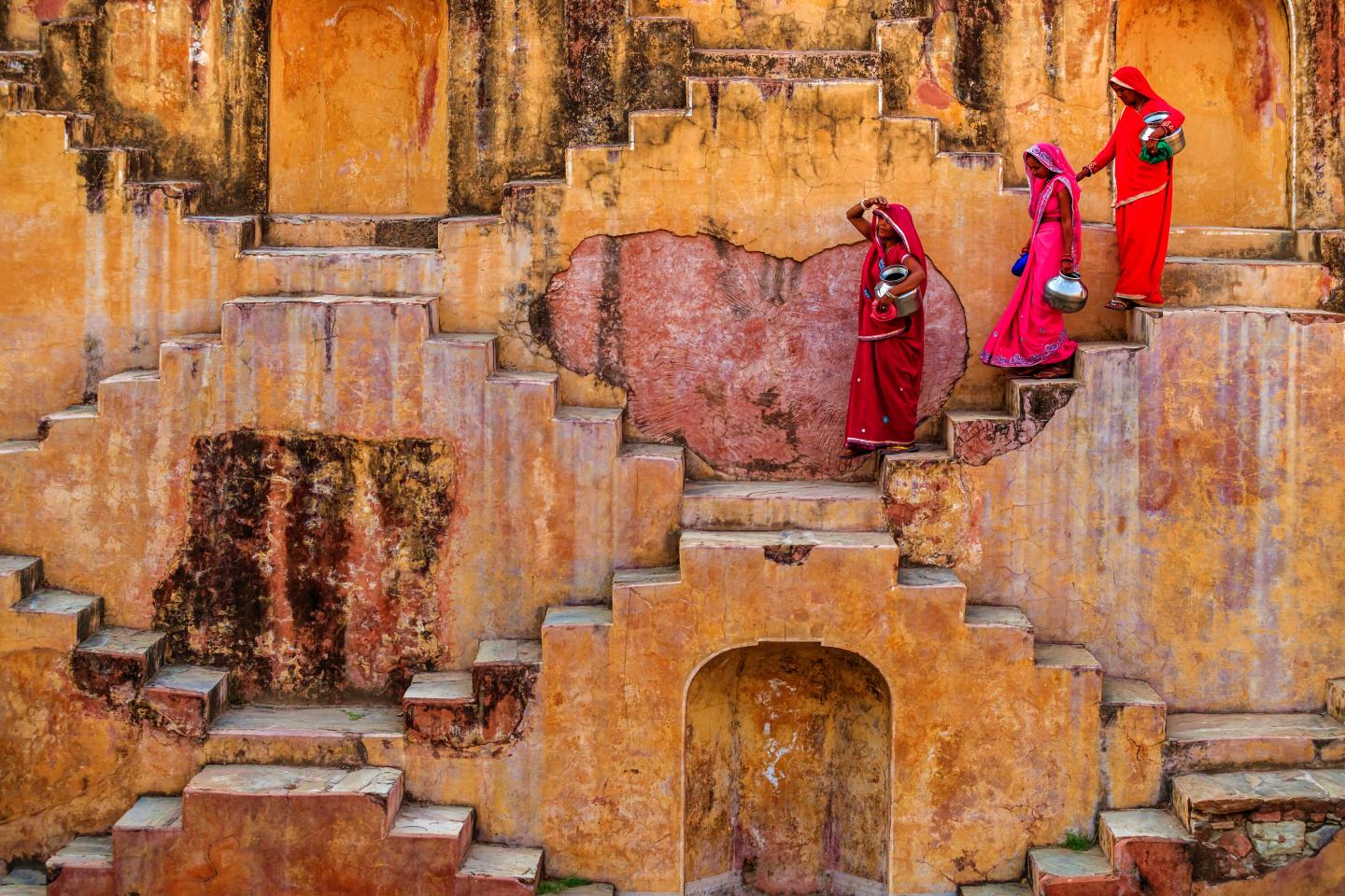 Indian women descent a step well. Sustainability water for all innovation. 